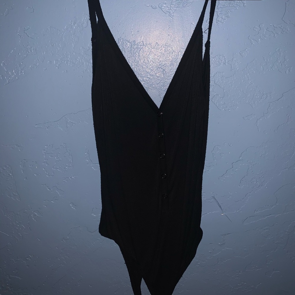 All black onesie button up.